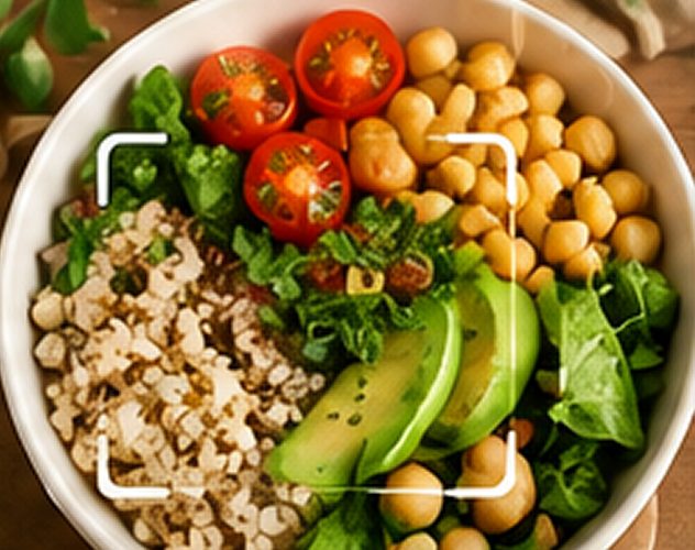 Bowl of quinoa, chickpeas, cherry tomatoes, avocado and greens